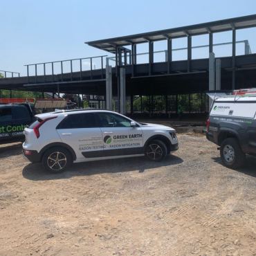 Green Earth Remediation vehicles at commercial building site