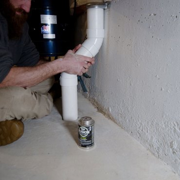 Installation of radon mitigation piping in a commercial building by Green Earth Remediation.