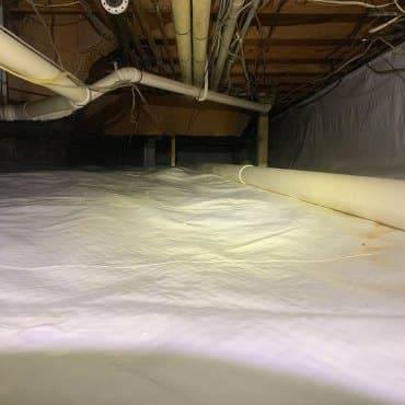 Radon barrier installation in a commercial crawlspace by Green Earth Remediation to prevent radon entry.