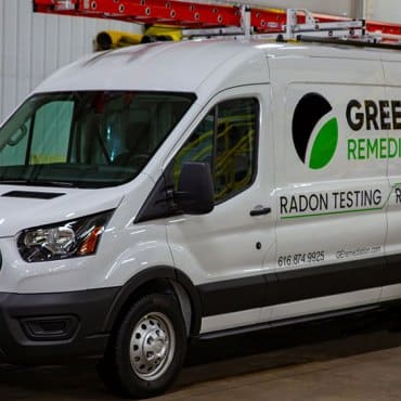Close-up of Green Earth Remediation's van detailing radon testing and mitigation services offered to businesses.