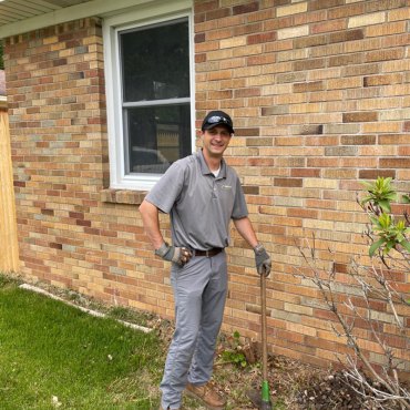Green Earth Remediation professional ready with pest control equipment for a homeowner's service.