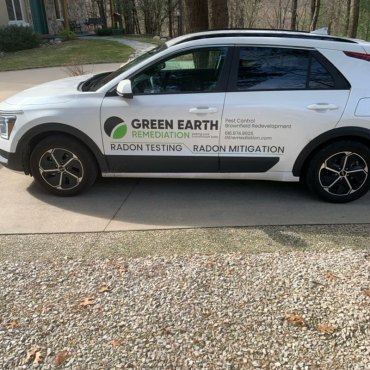 Green Earth Remediation's radon testing van parked at a residential site, ready for comprehensive radon assessment.