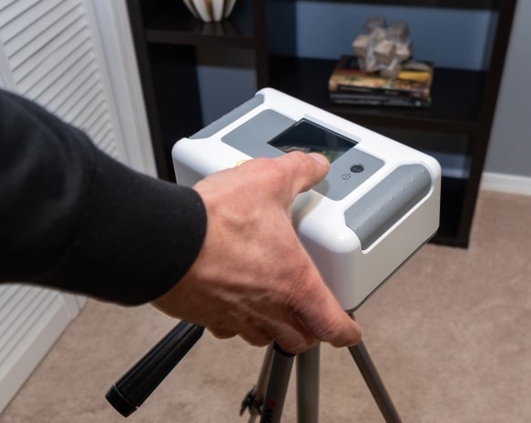 Commercial radon testing equipment being set up by Green Earth Remediation technician.