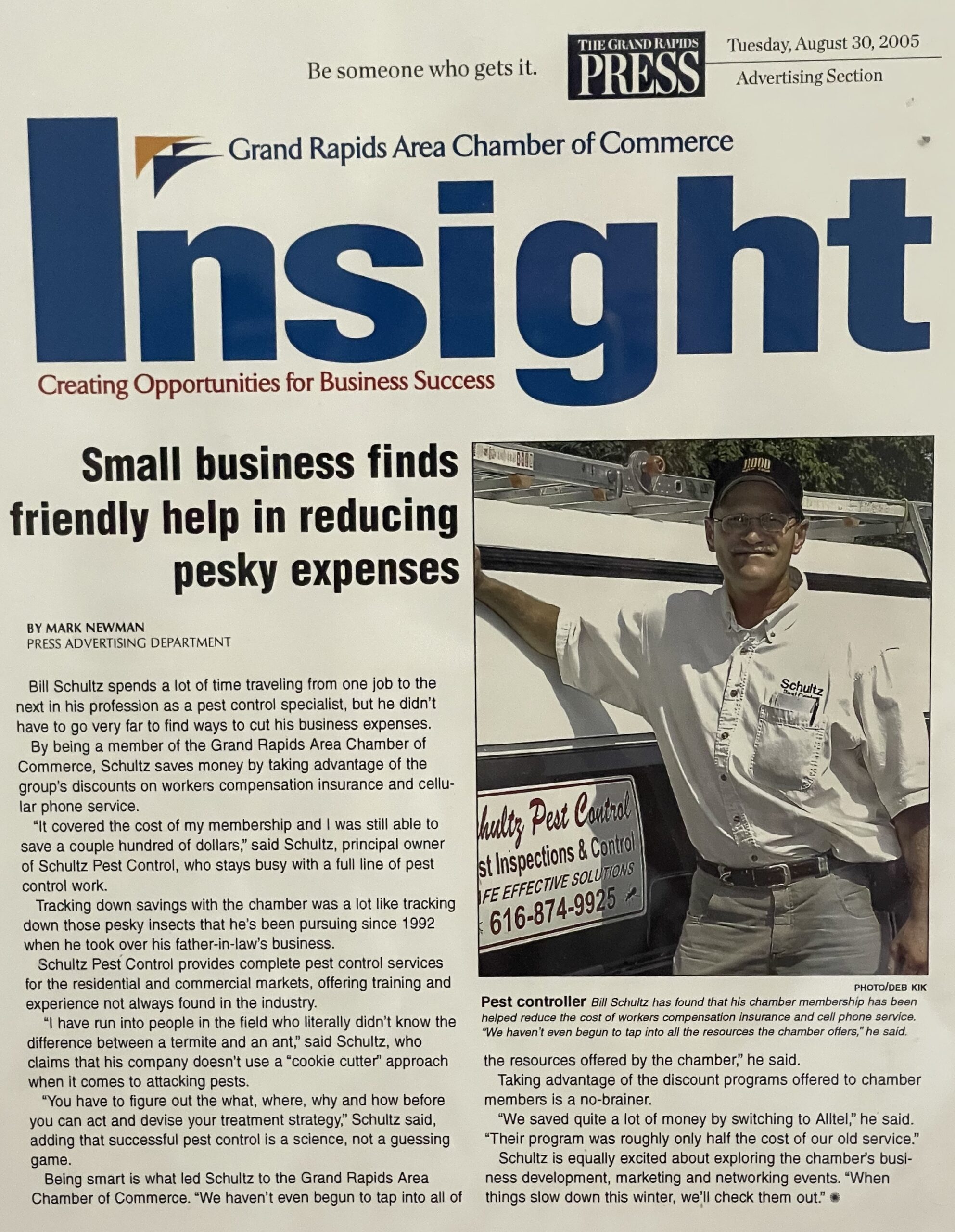 Bill Schultz standing next to his pest control vehicle, showcasing his success in reducing business expenses by taking advantage of Grand Rapids Area Chamber of Commerce resources in 2005.
